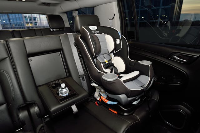 Clean luxury sedan interior with a child safety seat properly installed in the rear